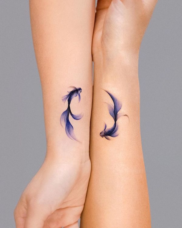 Matching purple koi fish wrist tattoos by @e.nal_.tattoo