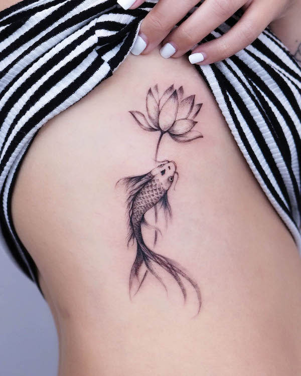 Koi fish and lotus flower tattoo by @vivi_tattooer