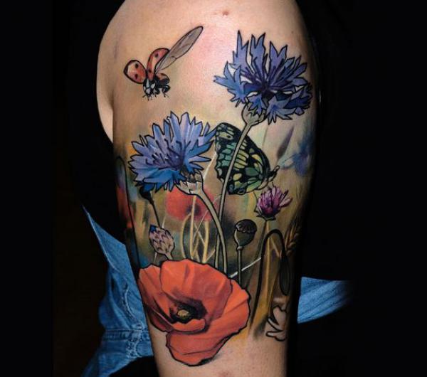 Cornflower and poppy with bee and butterfly half sleeve tattoo