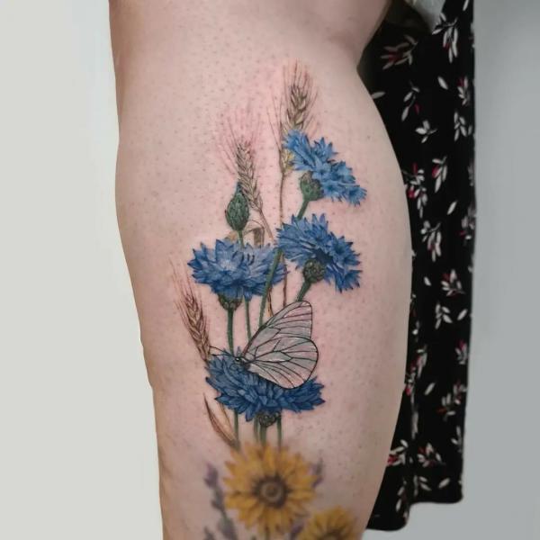 Cornflower sunflower and ears of wheat with butterfly tattoo
