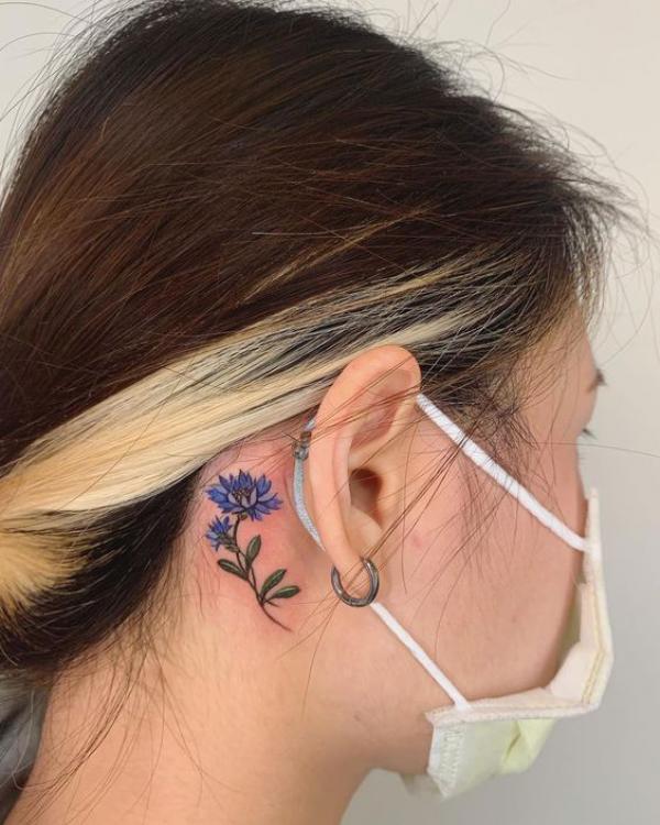 Cornflower tattoo behind ear