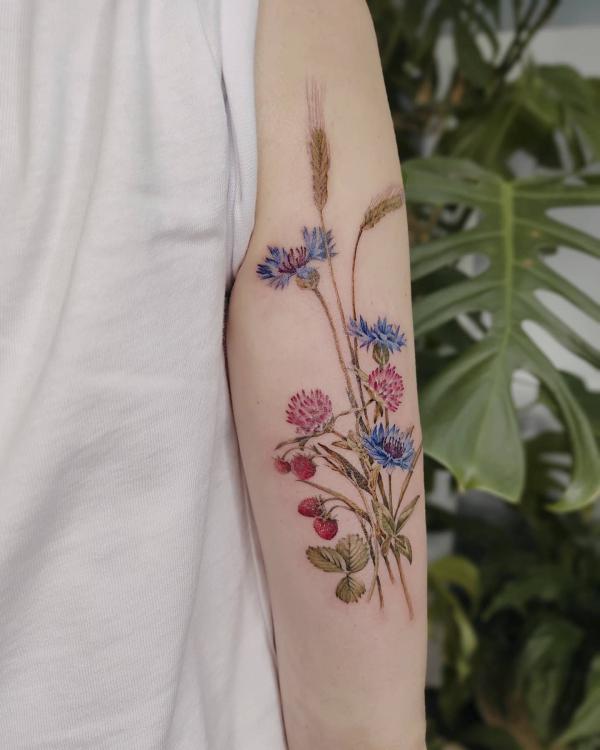 Cornflower thistle strawberry and ears of wheat tattoo