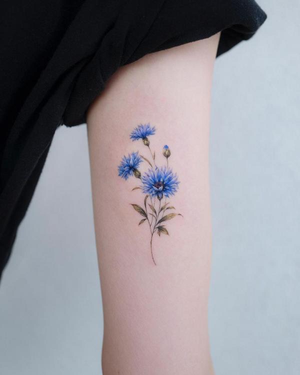 Minimalist cornflower bicept tattoo