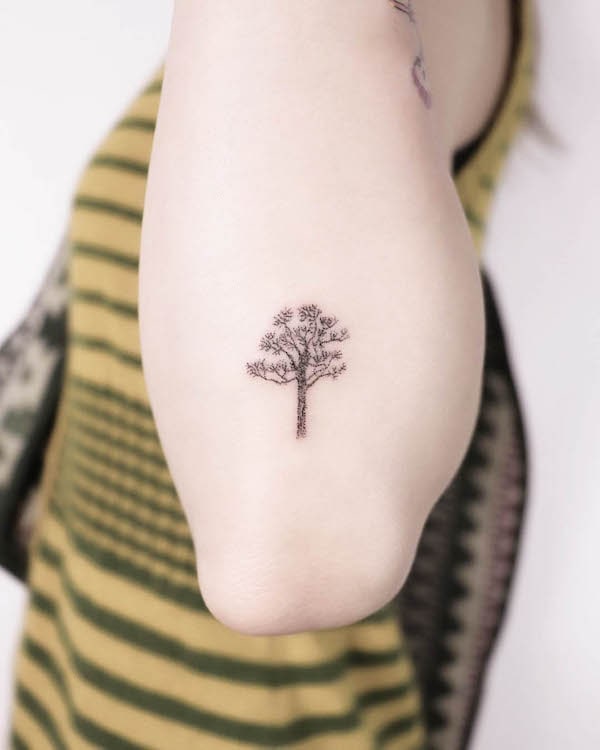 Tiny tree elbow tattoo by @surfboy_handpoke