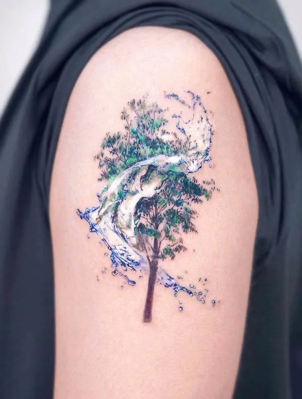 Tree and swirl upper arm tattoo by @stuffie.ink