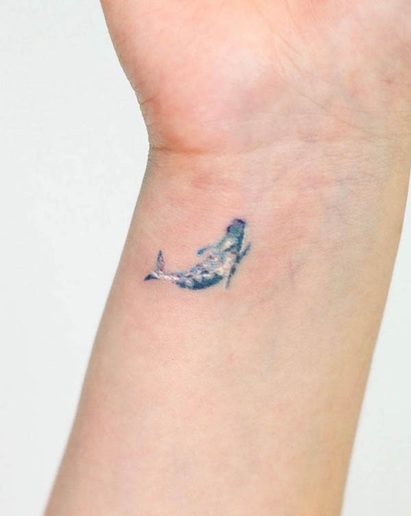 Tiny whale wrist tattoo by @han.ddam_tt