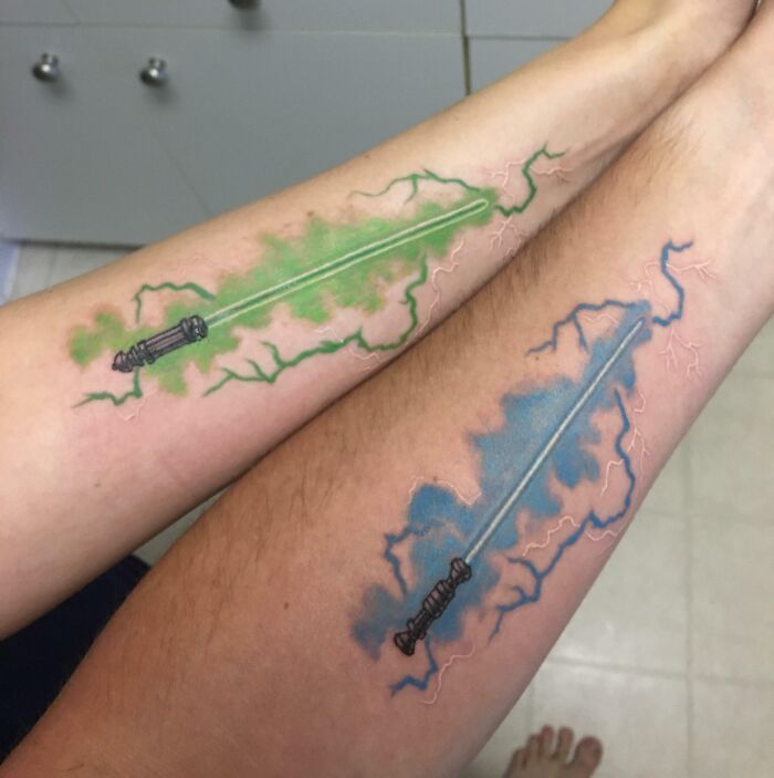 Colorful lightsabers matching forearm tattoos