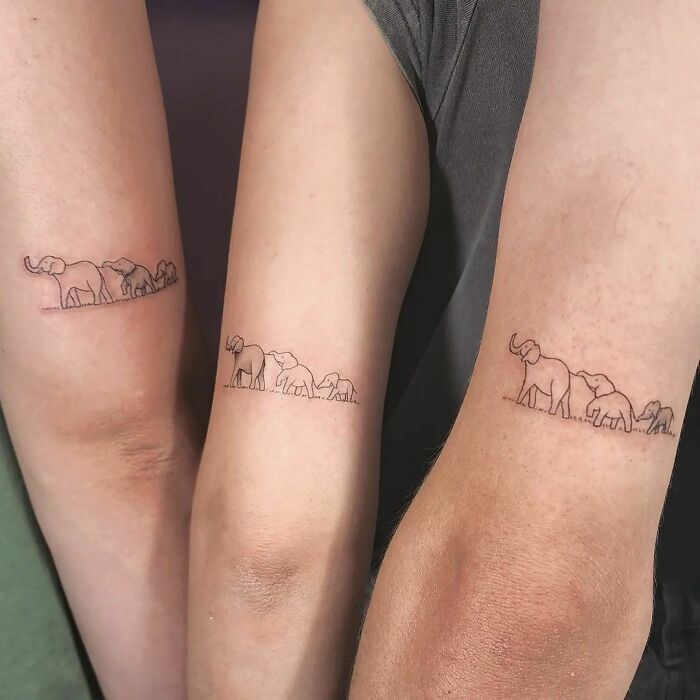 Three lephants following each other elbow tattoos