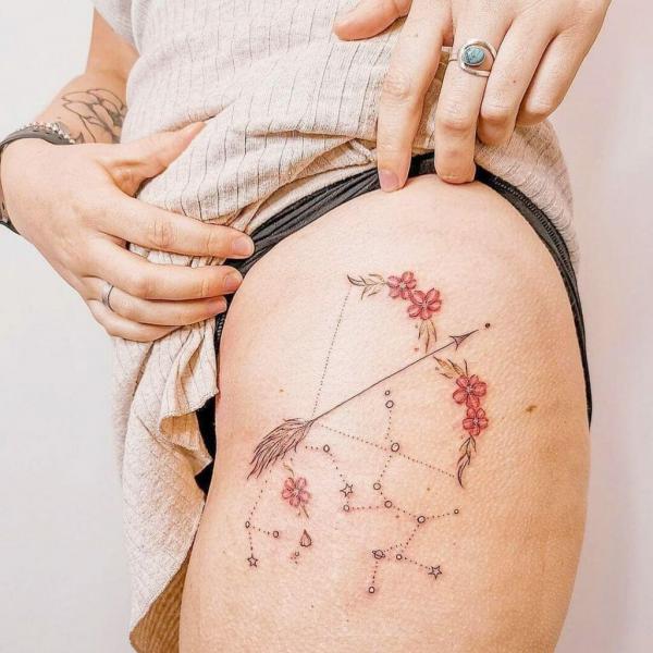 Sagittarius Constellation with floral bow and arrow tattoo