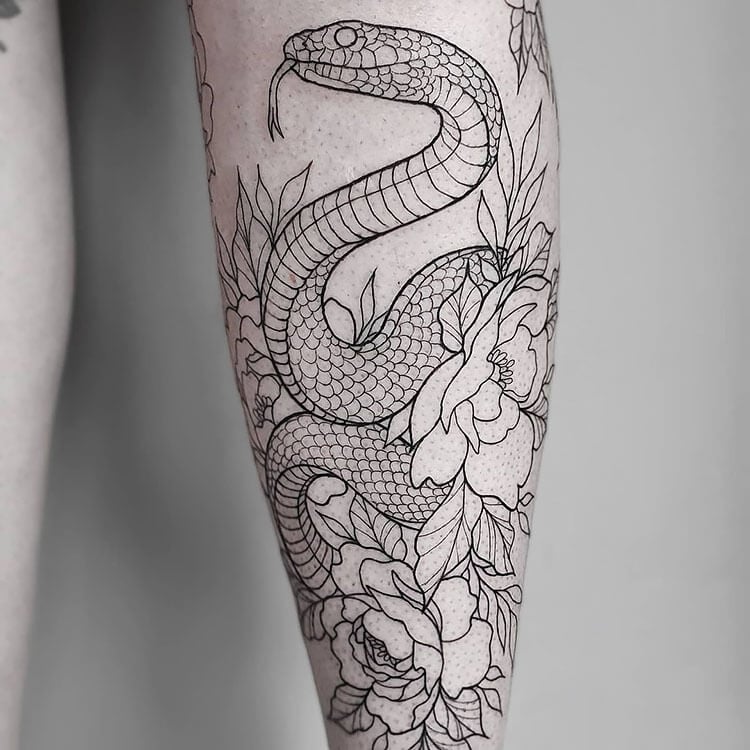 black and white snake with flowers tattoo