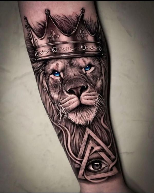 All seeing eye and Lion king tattoo on forearm