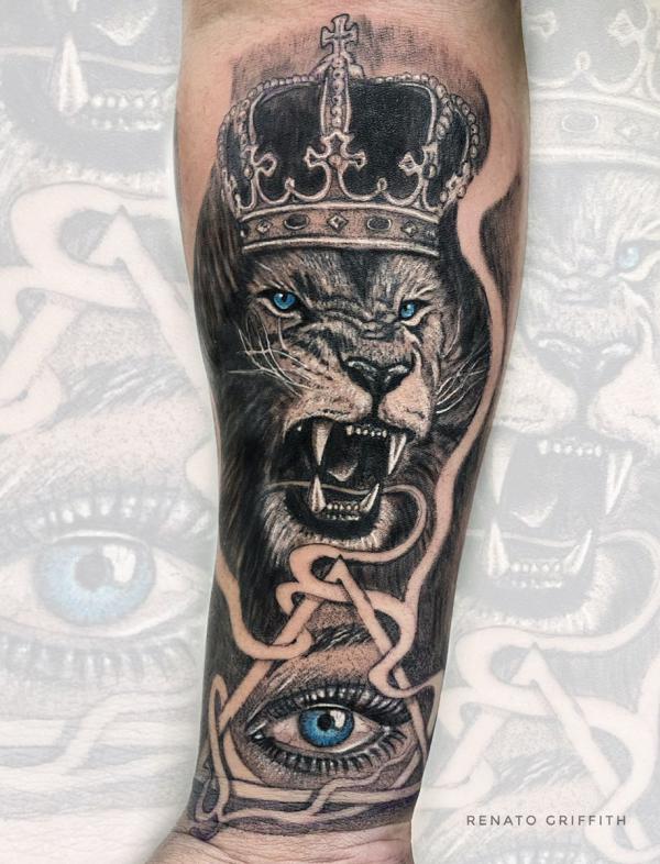 Angry lion king and all seeing eye tattoo