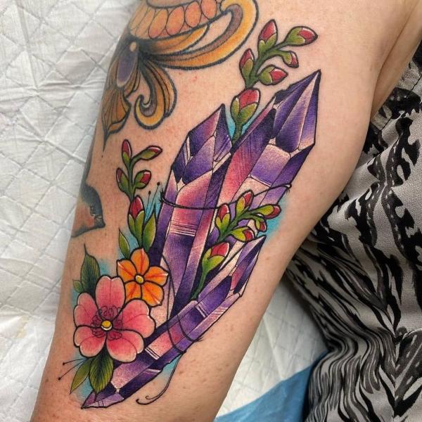 Crystal with plant and flowers tattoo