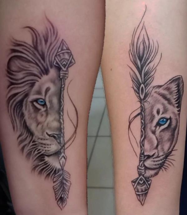 Half Lion king half lioness with arrows tattoo