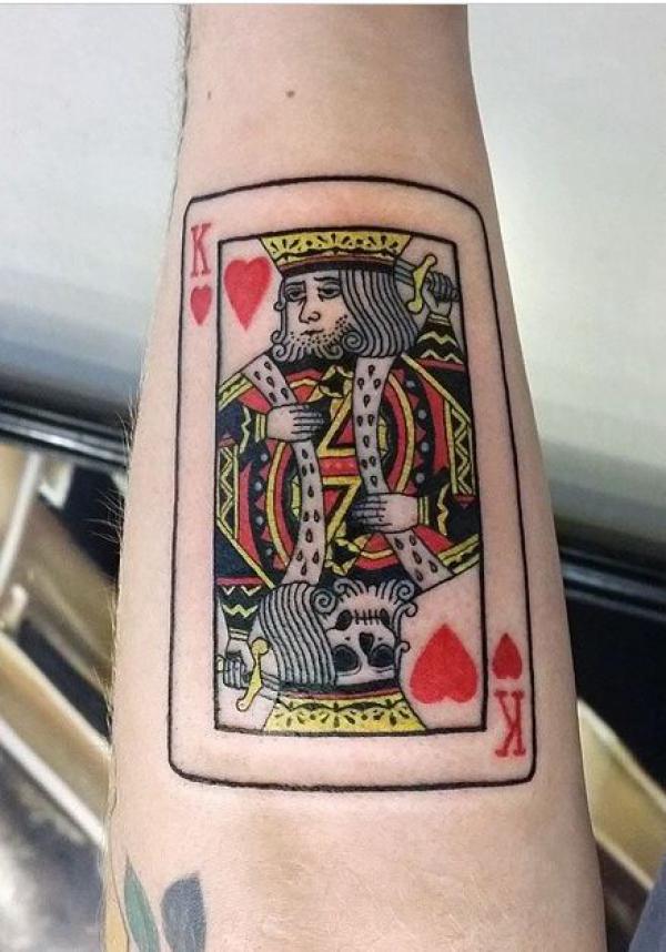 King playing card tattoo forearm