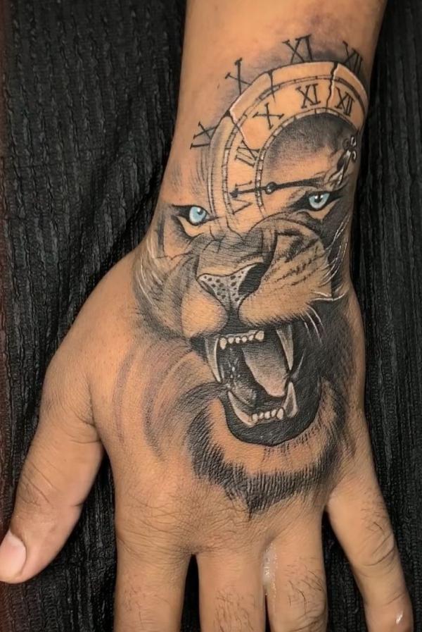 Lion king and clock tattoo hand