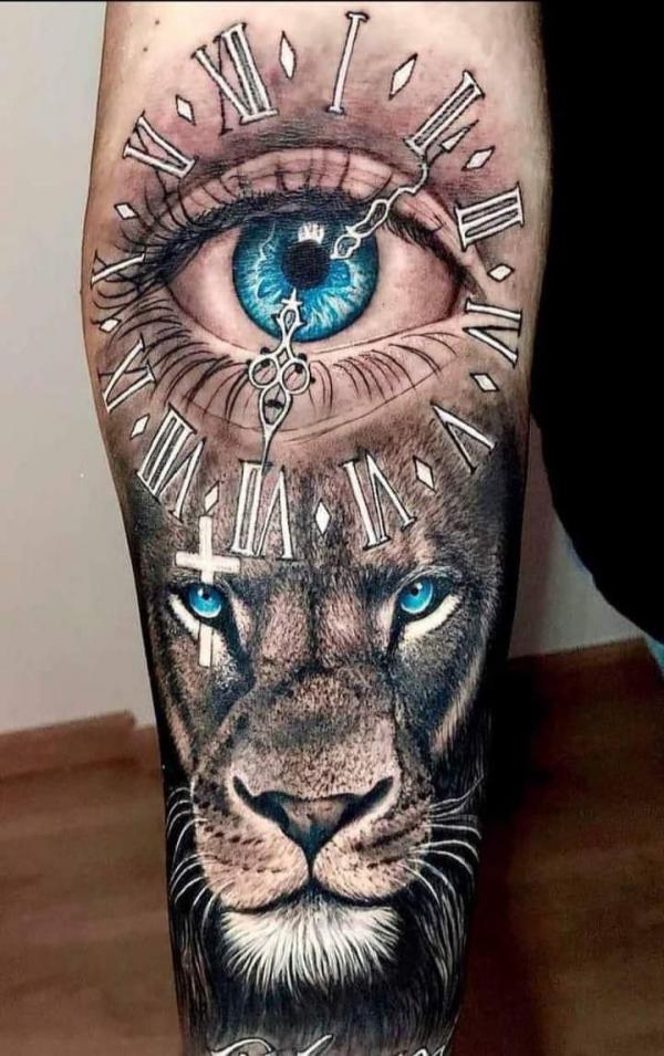 Lion king face and clock with eye tattoo