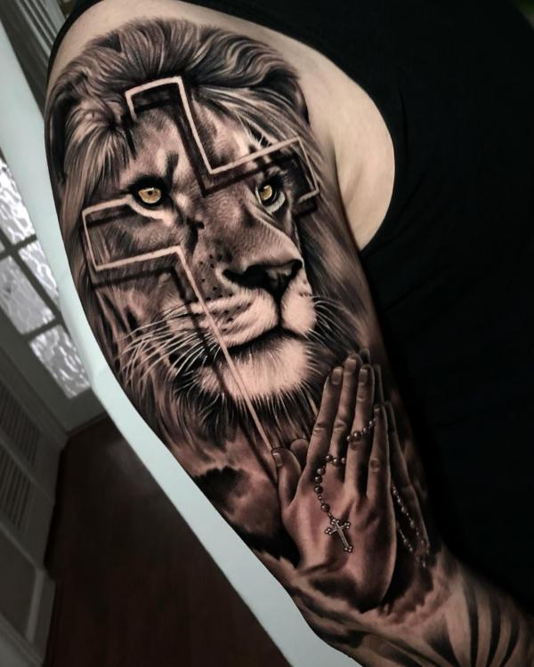 Lion king with cross and praying hands tattoo