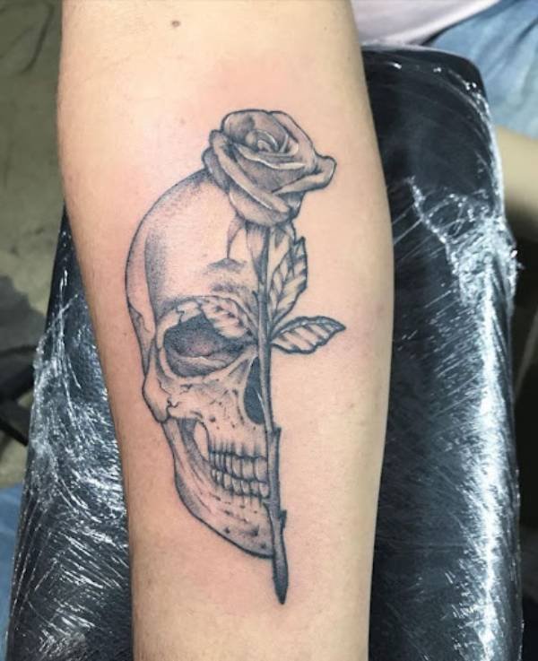 half rose and skull on arm tattoo