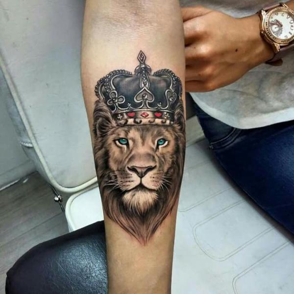 Small Lion king tattoo on inner forearm