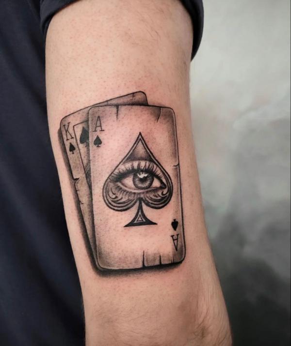 Spade playing cards back of arm tattoo