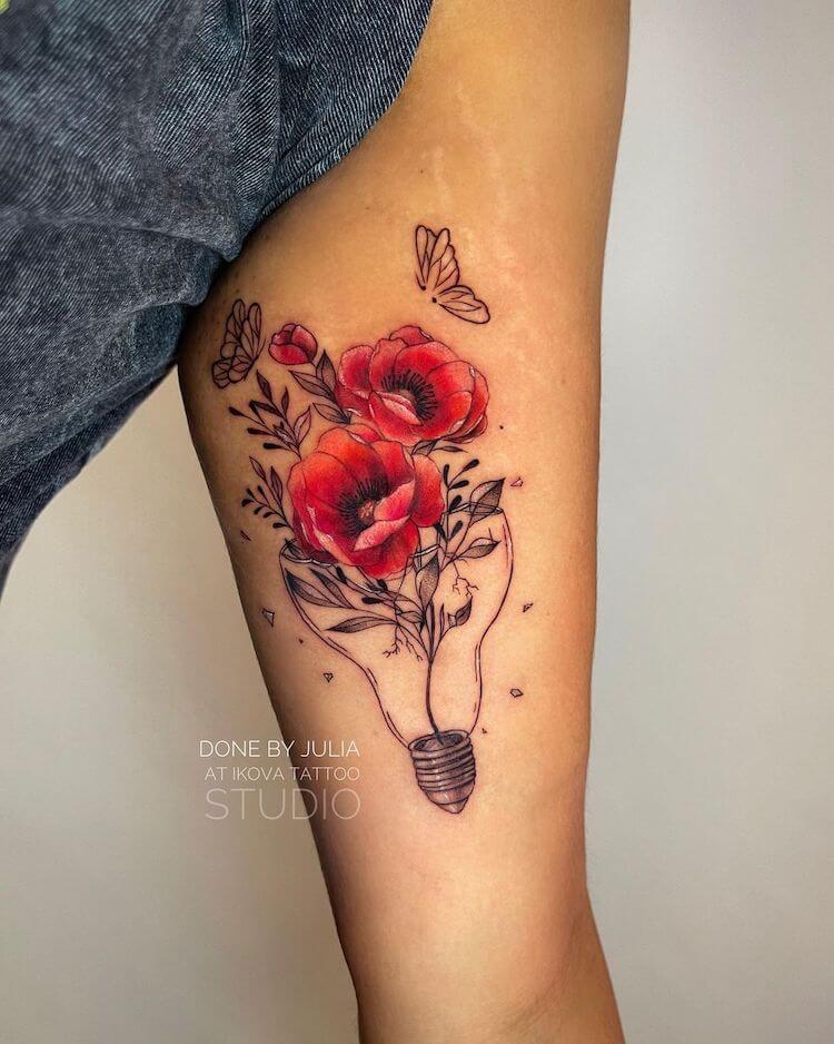 bicep tattoo with poppy and lightbulb