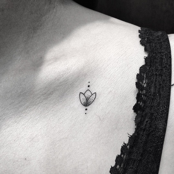 Minimal flower tattoo near the collarbone