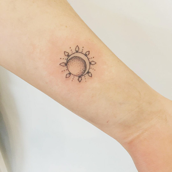 Simple sun and moon tattoo on arm