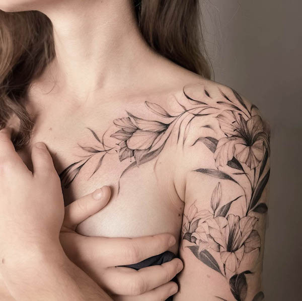 Black and grey floral chest to shoulder tattoo by @ela_fine_tattoo