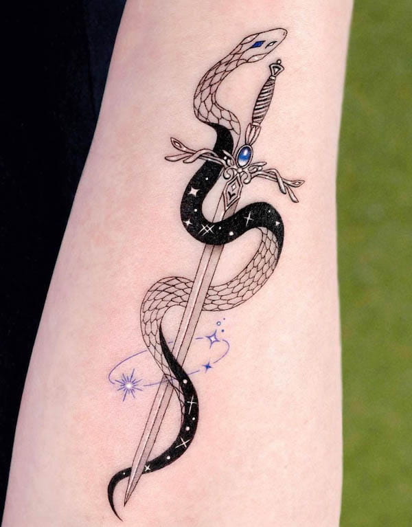 Black and white snake with dagger tattoo by @tattooist_solar