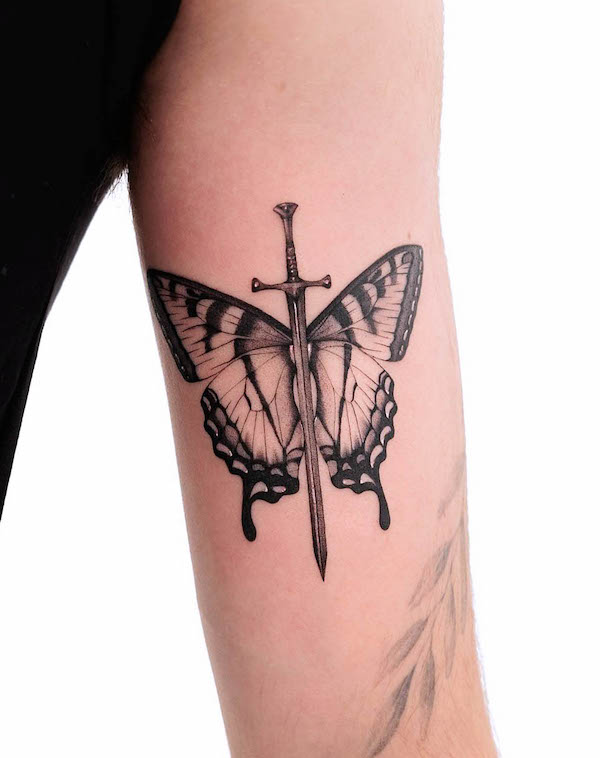 Butterfly dagger bicep tattoo by @aquatica_tattoo