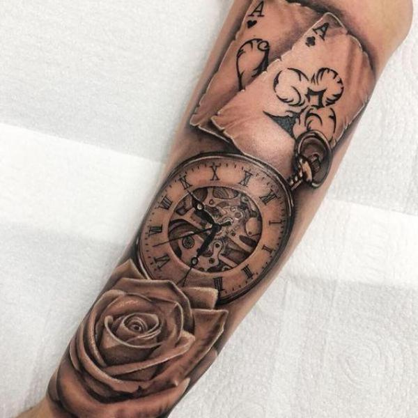 Cards and rose with pocket watch tattoo arm