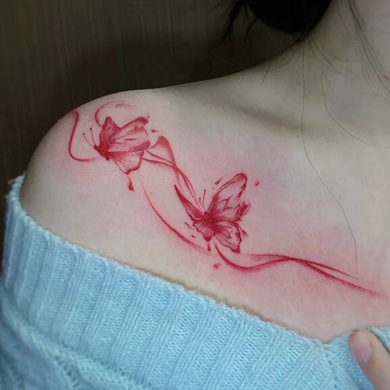 Red watercolor butterfly clavicle tattoo