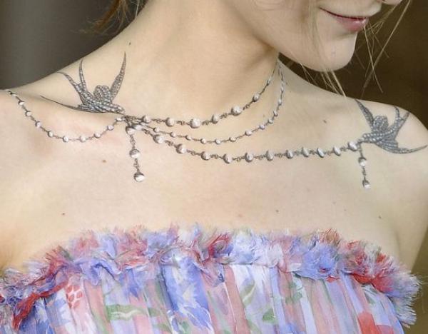 Swallow and pearl necklace tattoo