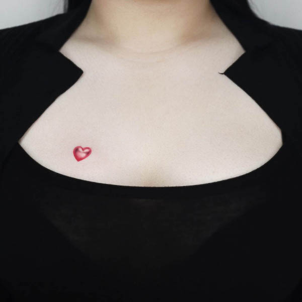 Tiny red heart chest tattoo by @jooa_tattoo