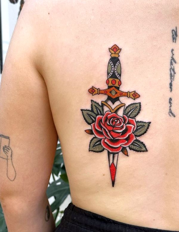 Traditional rose and dagger tattoo by @micablancotattoos