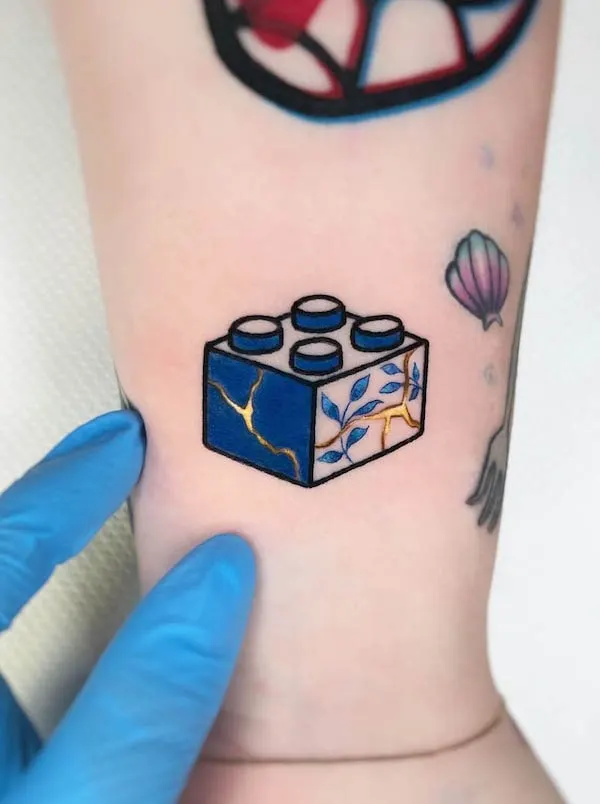 Cute small lego tattoo by @sonia_tessari