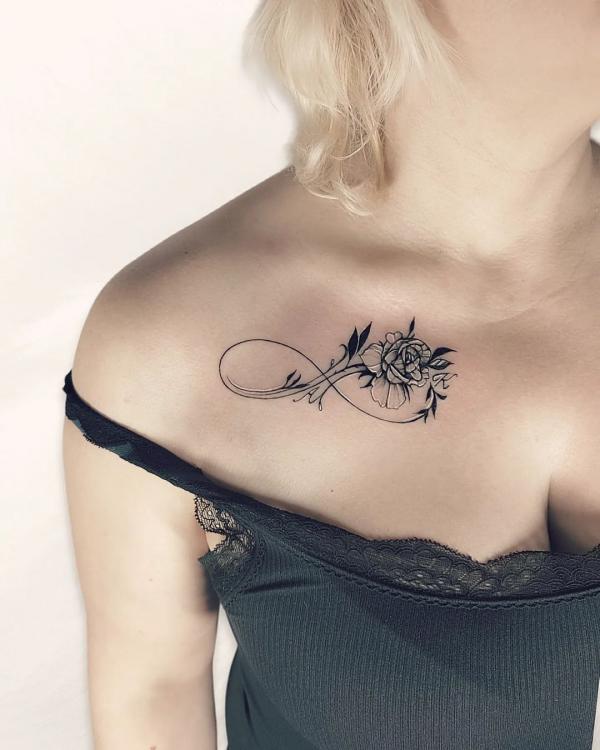 Elegant black and white rose infinity collarbone tattoo