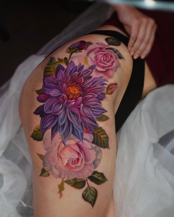 Purple dahlia and pink rose tattoo on the side of hip