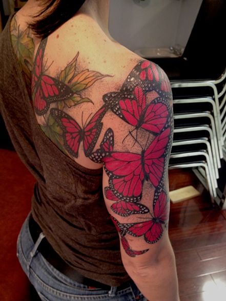 Red butterflies arm and shoulder tattoo