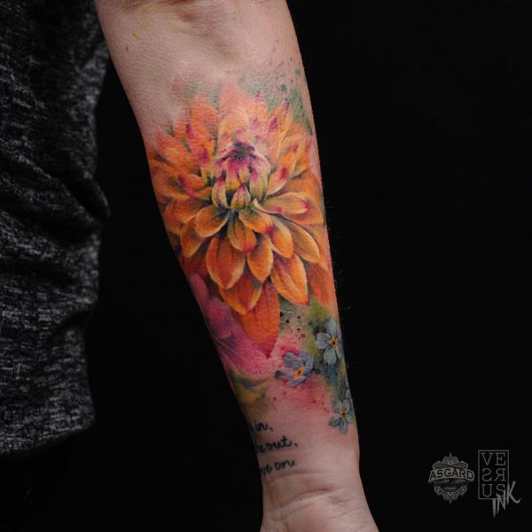 Watercolor dahlia tattoo on forearm