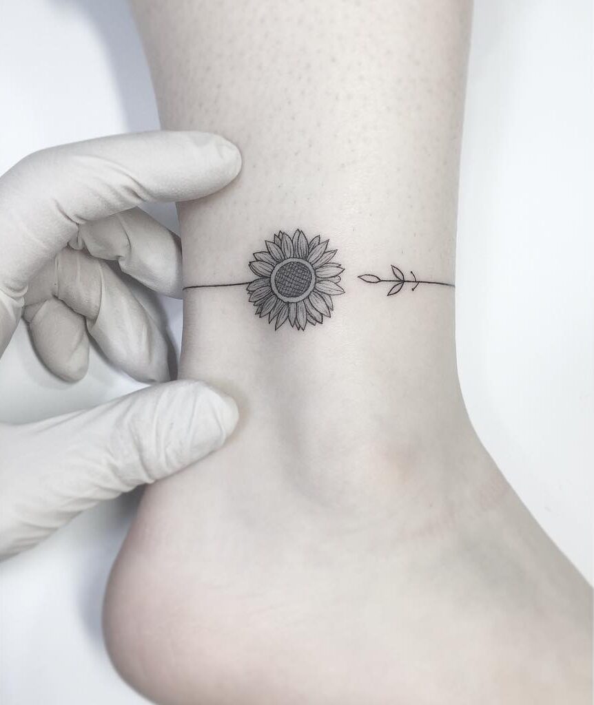 Sunflower anklet tattoo done in illustrative style