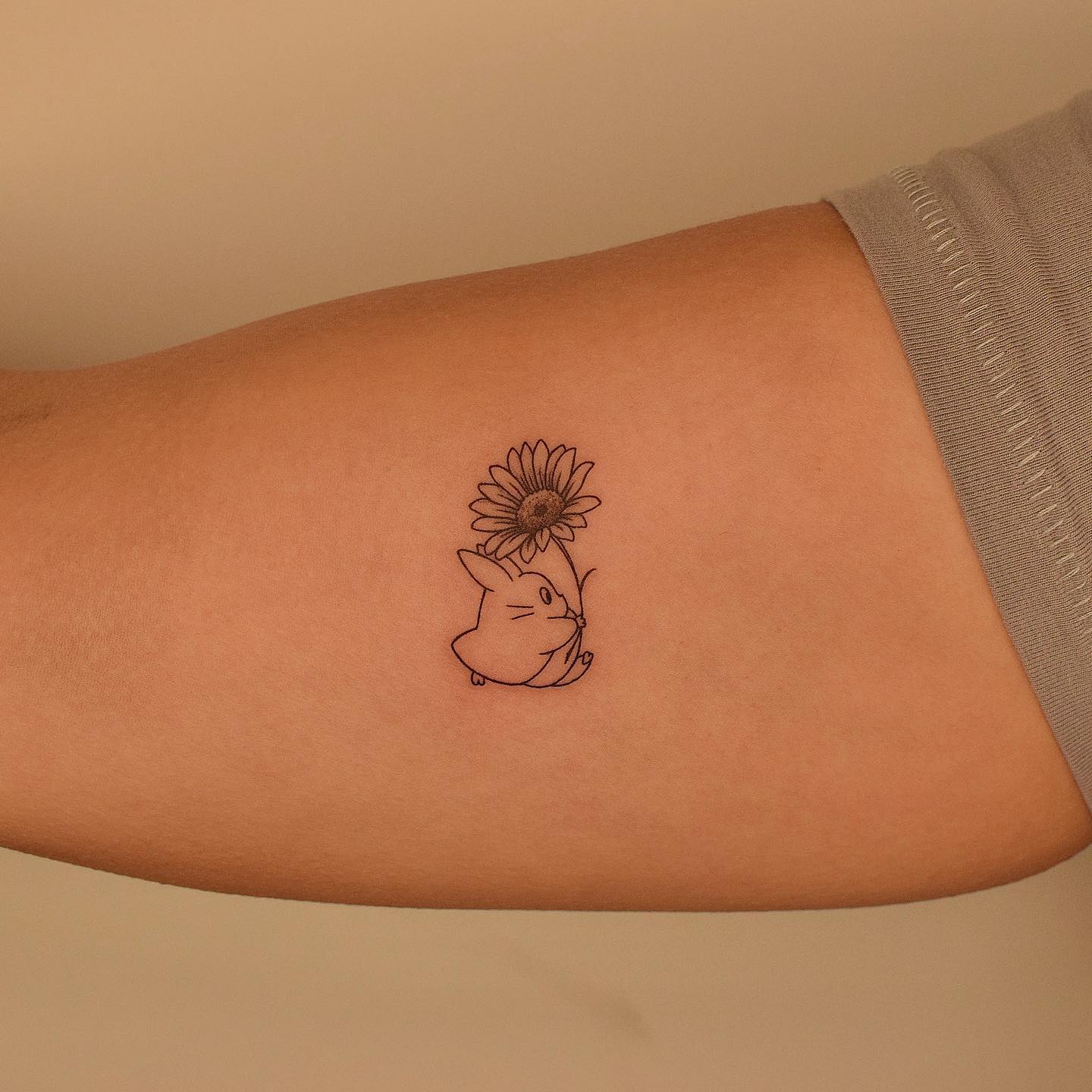 Chuu Totoro and sunflower tattoo on the inner arm