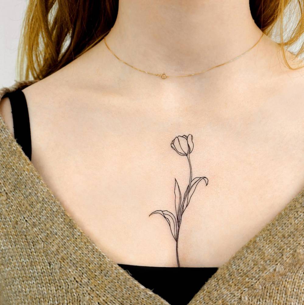 Fine line style tulip tattoo on the chest