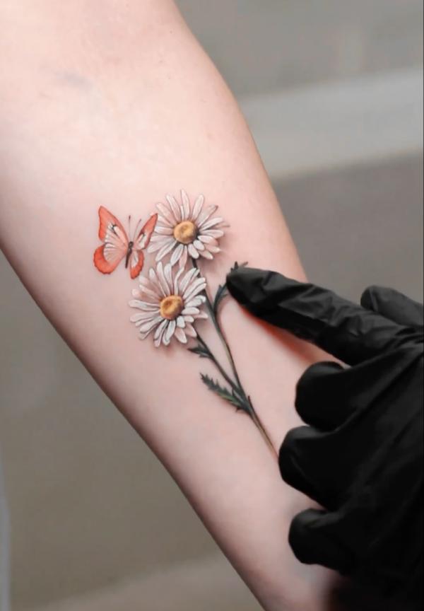 Red and white butterfly and daisy tattoo