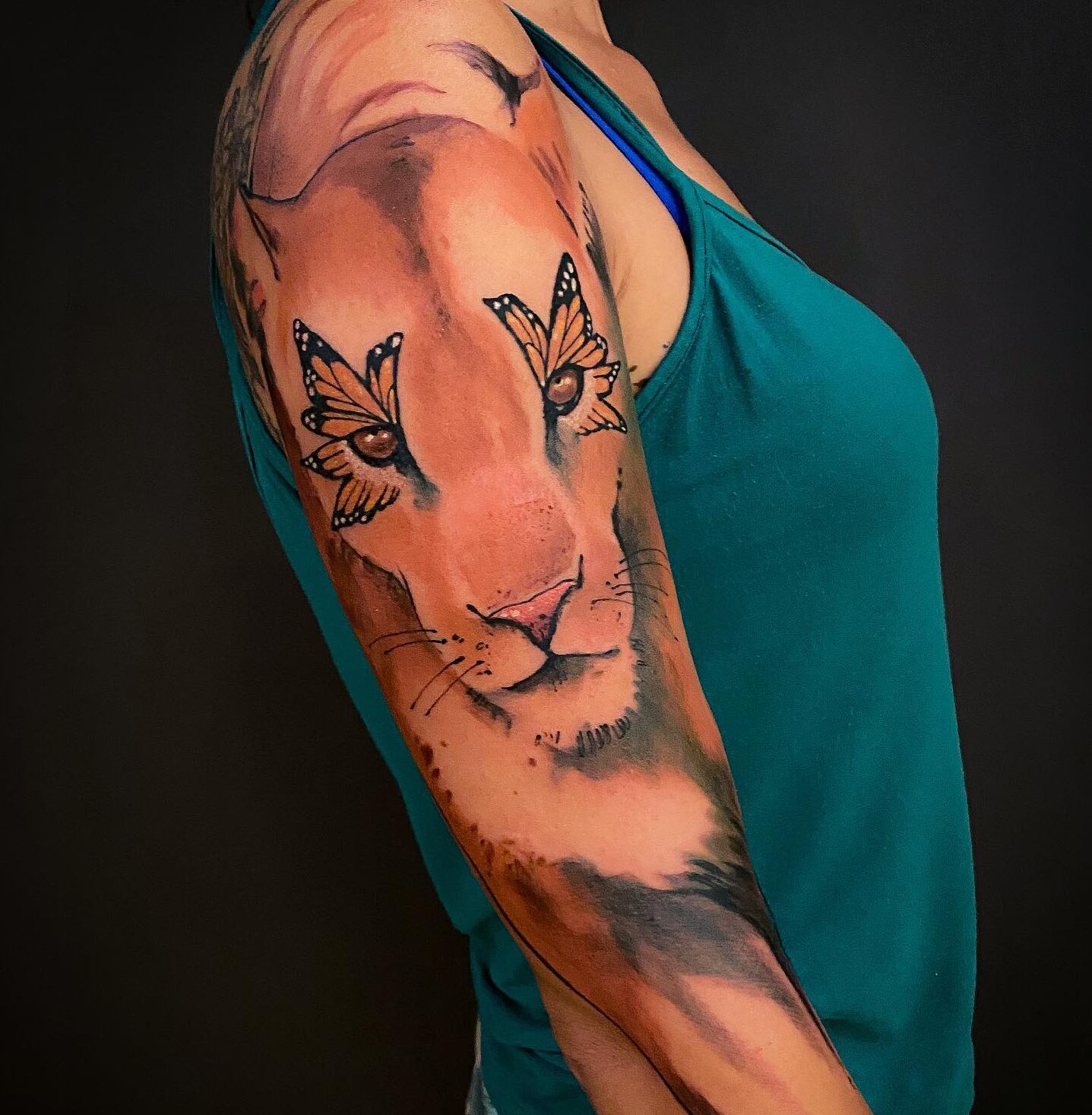 Huge lioness tattoo on the arm