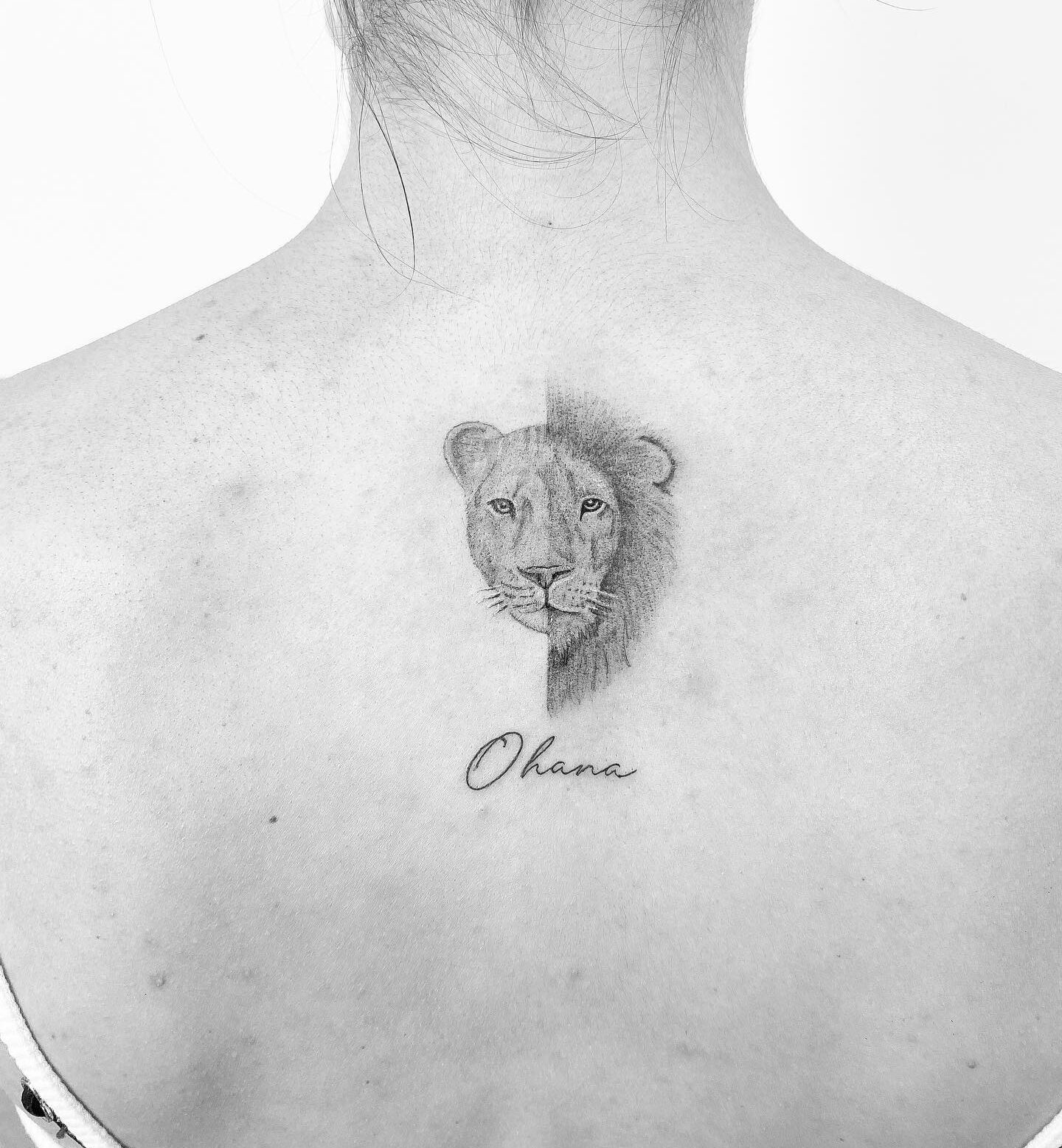 Lion and lioness tattoo on the upper back