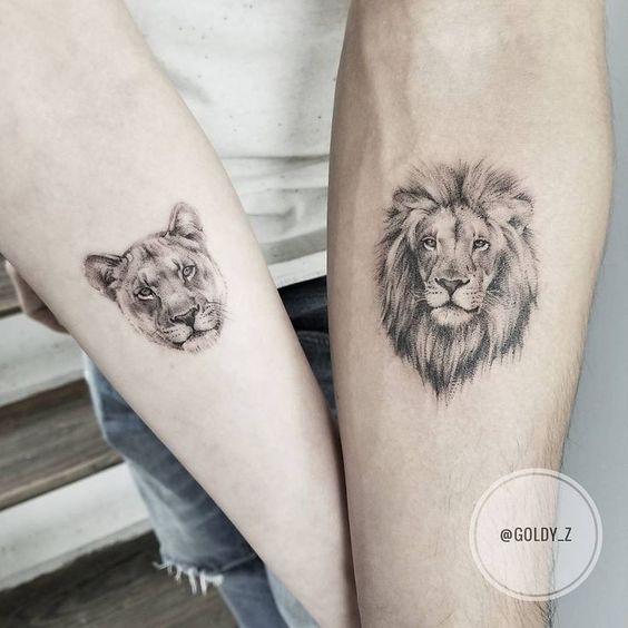 Lion and lioness couple tattoo on the inner forearm