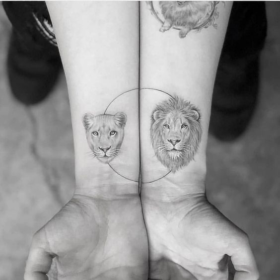 Lion and lioness tattoo on the wrist