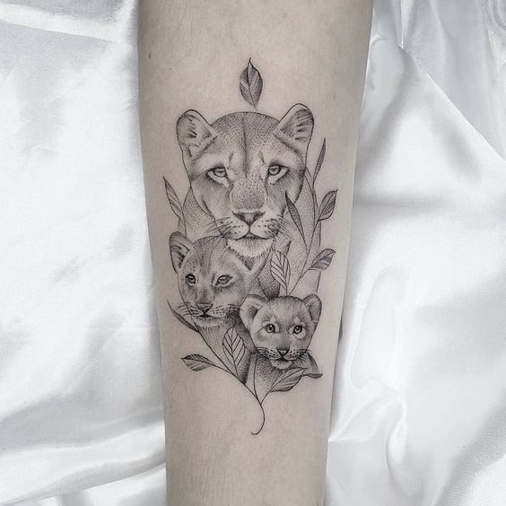 Lioness and lion cubs tattoo on the forearm